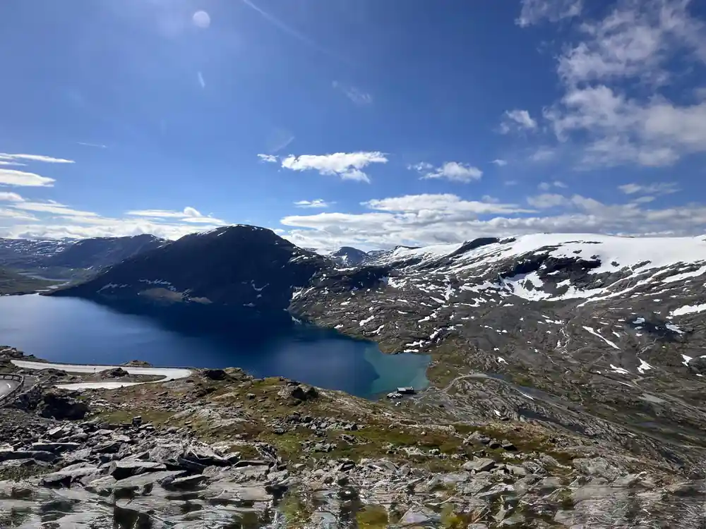 Alpine lake surrounded by rocky mountains and sparse vegetation