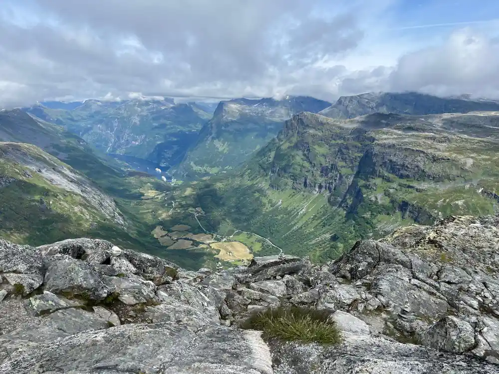 Alpine valley with farms and mountains from high viewpoint