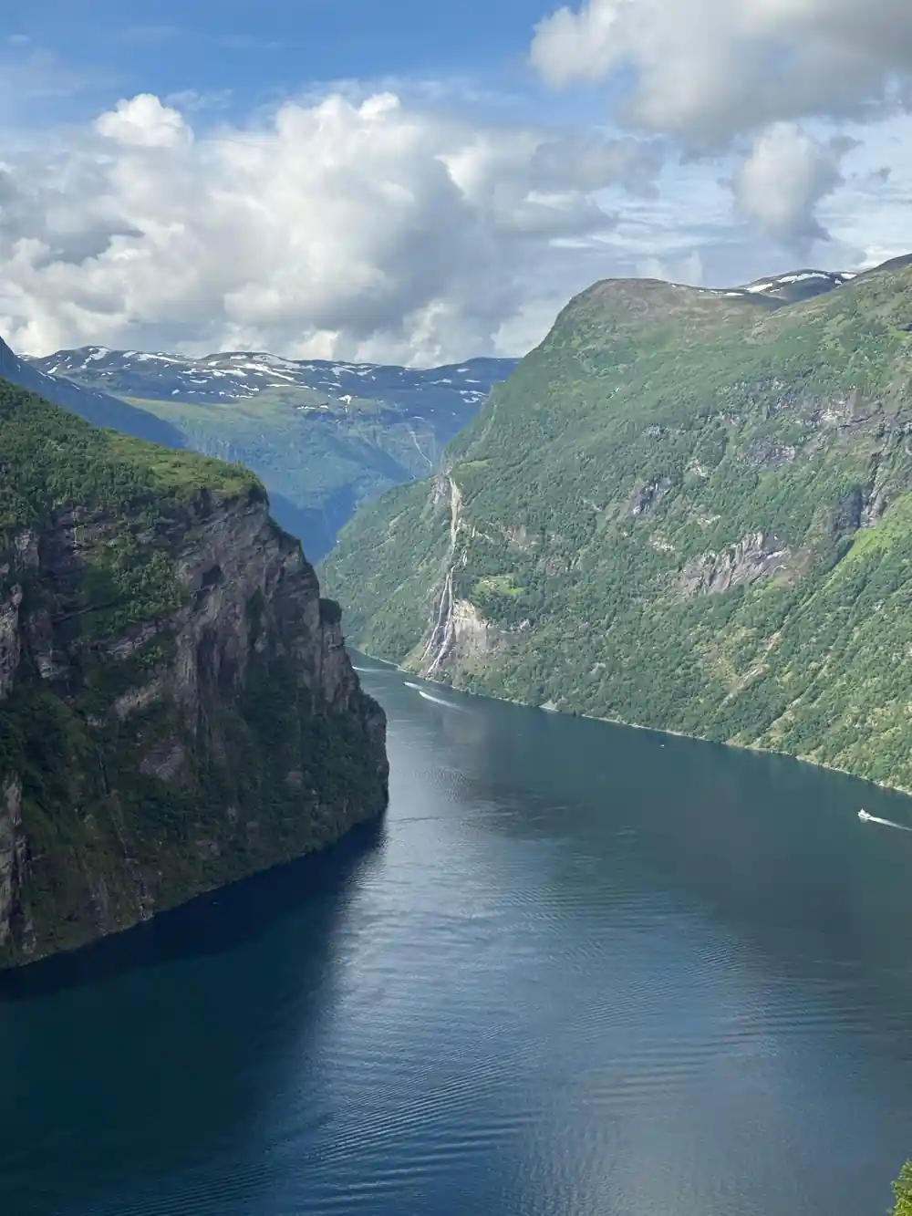 Cruise ships in narrow fjord between steep cliffs