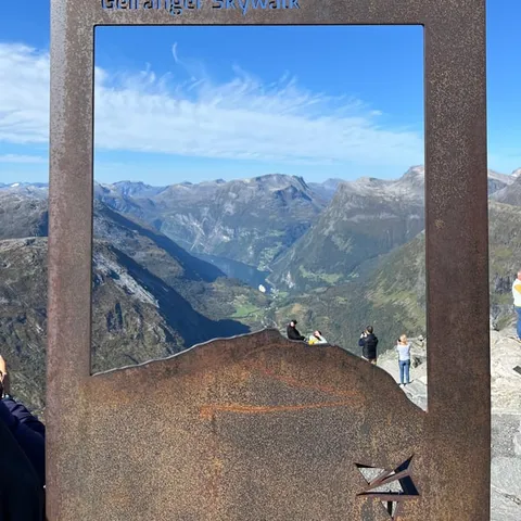 Steel picture frame on the Dalsnibba Skywalk above the mountains