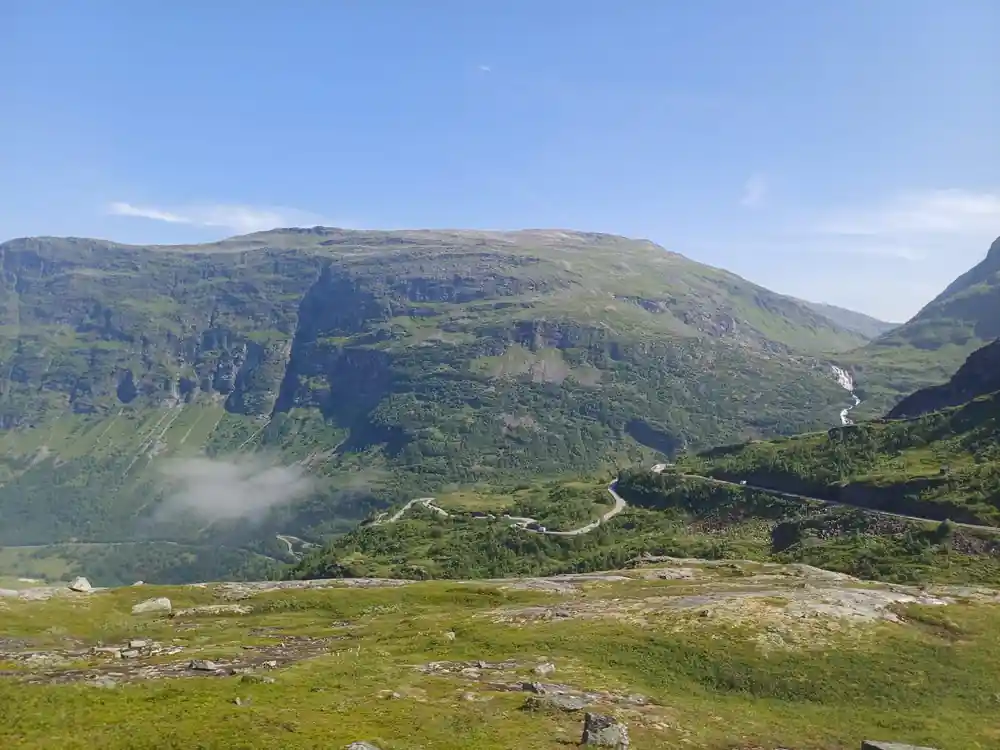 Mountain valley with road winding through green landscape