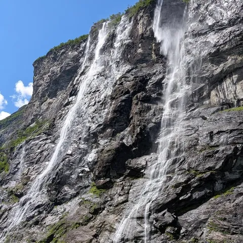 The Seven Sisters waterfall streaming down a dark cliff face