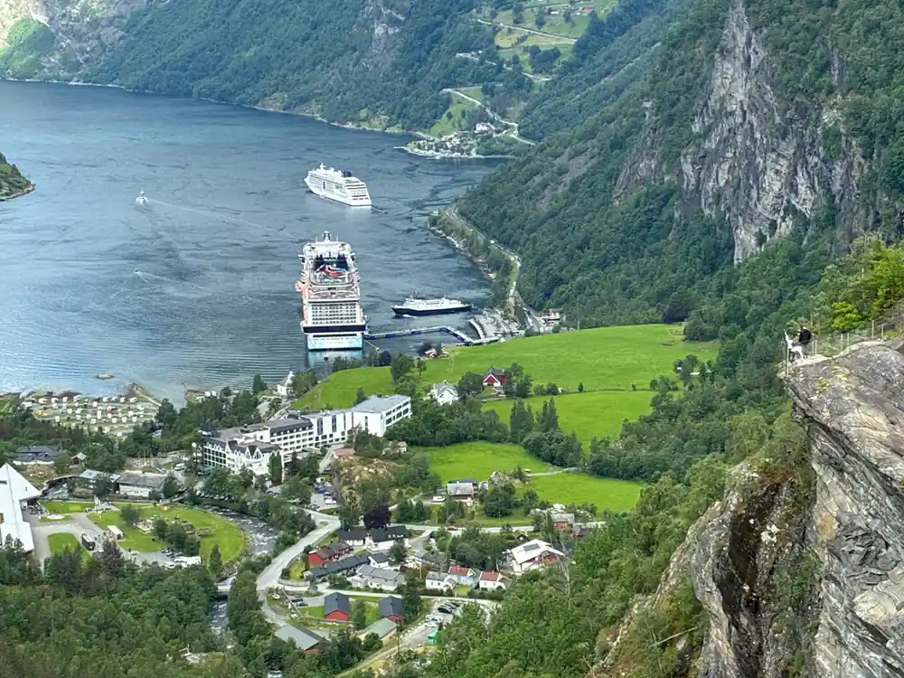 Steep fjord with cruise ship, hotel and cable car station
