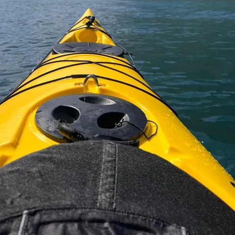 Yellow double kayak gliding on the Geirangerfjord